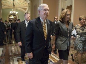 Senate Majority Leader Mitch McConnell, R-Ky, heads to a meeting with Treasury Secretary Steven Mnuchin, Trump's top economic adviser Gary Cohn, and members of the Senate Budget Committee as they struggle with a tax code overhaul that will add to the deficit as they work on a GOP budget plan that's a prerequisite to any far-reaching change in the nation's tax system, at the Capitol in Washington, Tuesday, Sept. 12, 2017. (AP Photo/J. Scott Applewhite)