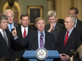Sen. Lindsey Graham, R-S.C., joined by, from left, Sen. Roy Blunt, R-Mo., Majority Whip John Cornyn, R-Texas, Sen. John Barrasso, R-Wyo., Sen. Bill Cassidy, R-La., Senate Majority Leader Mitch McConnell, R-Ky., and Sen. John Thune, R-S.D., speaks to reporters as he pushes a last-ditch effort to uproot former President Barack Obama's health care law, at the Capitol in Washington, Tuesday, Sept. 19, 2017. To win, 50 of the 52 GOP senators must back it _ a margin they failed to reach when the chamber rejected the effort in July. (AP Photo/J. Scott Applewhite)