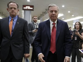 Sen. Pat Toomey, R-Pa., left, and Sen. Lindsey Graham, R-S.C., arrive at the Capitol in Washington, Tuesday, Sept. 26, 2017. (AP Photo/J. Scott Applewhite)