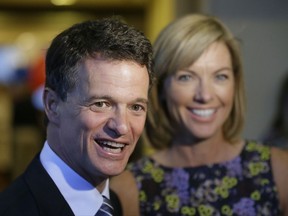 In this Aug. 5, 2014 file photo, Republican David Trott, a candidate for Michigan's 11th congressional district, stands next to his wife, Kappy, during an interview at his election night party in Troy, Mich. In a statement Monday, Sept. 11, 2017, Rep. Dave Trott, R-Mich., says he will not seek re-election. (AP Photo/Carlos Osorio)