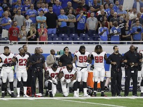 Atlanta Falcons defensive tackles Grady Jarrett (97) and Dontari Poe (92) take a knee during the national anthem before an NFL football game, Sunday, Sept. 24, 2017, in Detroit. (AP Photo/Carlos Osorio)