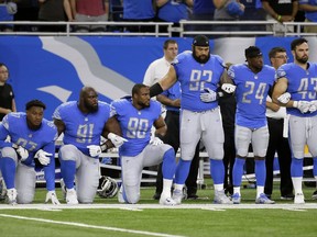Detroit Lions defensive end Armonty Bryant (97), defensive tackle A'Shawn Robinson (91) and defensive end Cornelius Washington (90) take a knee during the national anthem before an NFL football game against the Atlanta Falcons, Sunday, Sept. 24, 2017, in Detroit. (AP Photo/Duane Burleson)