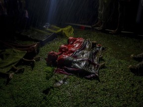 Bodies of Rohingya Muslim children, who died after their boat capsized in the Bay of Bengal as they were crossing over from Myanmar into Bangladesh, lies on a roadside near Inani beach, in Cox's Bazar district, Bangladesh, Thursday, Sept. 28, 2017. (AP Photo/Dar Yasin)