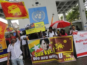 A group of Sri Lankan hardline Buddhists protest outside the U.N. office in Colombo, Sri Lanka, Wednesday, Sept. 27, 2017. The protestors expressed their solidarity with Buddhists in Myanmar and opposed any move to bring Rohingya refugees to Sri Lanka. Placards in center reads "We do not want any Rohingya extremists who killed Buddhist monks." (AP Photo/Eranga Jayawardena)