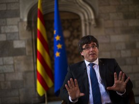 Catalonia's regional president, Carles Puigdemont speaks during an interview with The Associated Press at the Palace of Generalitat or Catalan government headquarters, in Barcelona, Spain, Wednesday, Sept. 27, 2017. (AP Photo/Emilio Morenatti)