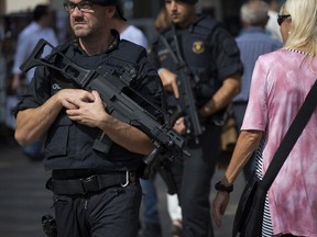 Police officers of Catalan Mossos d'Esquadra patrol in Barcelona, Spain Saturday, Sept. 23, 2017. Spain's Interior Ministry says that a state prosecutor has asked for the central government to coordinate the policing efforts to impede the referendum on Catalonia's secession from Spain. (AP Photo/Emilio Morenatti)