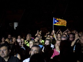 A man waves an Estelada or Independence flag during an event promoting the start of the campaigning for the ballot in Tarragona, about 100 kilometres south of Barcelona, Spain, Thursday, Sept. 14, 2017. Tension is mounting between Catalan and Spain's national leaders as Catalonia's president is set to open the "yes" campaign for a planned referendum on seceding from Spain Thursday. (AP Photo/Emilio Morenatti)