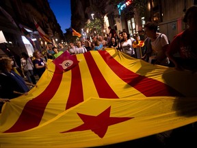 People demonstrate carrying esteladas or independence flags ahead of the Catalan National Day in Barcelona, Spain, Sunday Sept. 10, 2017. Hundred of thousands of people are expected to demonstrate in Barcelona to call for the creation of a new Mediterranean nation, as they celebrate the Catalan National Day holiday. (AP Photo/Emilio Morenatti)