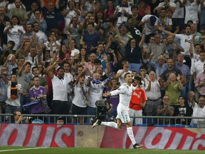 Real Madrid's Cristiano Ronaldo celebrates scoring his side's first goal during a Champions League group H soccer match between Real Madrid and Apoel Nicosia at the Santiago Bernabeu stadium in Madrid, Spain, Wednesday, Sept. 13, 2017. (AP Photo/Francisco Seco)