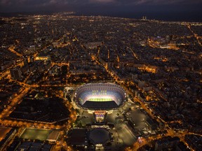 In this Tuesday, Sept. 19, 2017 photo, the Camp Nou stadium is illuminated in Barcelona, Spain. More than ever before, Barcelona will be more than just a club for Catalonia's separatists come Sunday. Barcelona's home match against Las Palmas falls on the day when secessionists have vowed to hold a referendum on independence from the rest of Spain. (AP Photo/Emilio Morenatti)