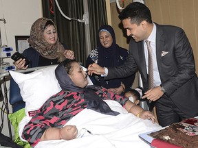 In this Monday, Sept.11, 2017 photo, Eman Abdul Atti receives a piece of cake from Dr. Shamsheer Vayalil during her 37th birthday party at the Burjeel Hospital in Abu Dhabi, United Arab Emirates.