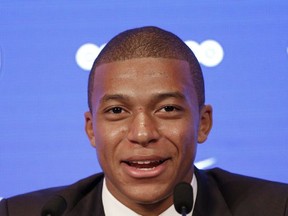 French soccer player Kylian Mbappe attends a press conference in Paris, Wednesday, Sept. 6, 2017. Mbappe is a young man in a big hurry and wants to "win everything" with his new club Paris Saint-Germain. (AP Photo/Christophe Ena)