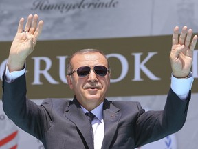 Turkey's President Recep Tayyip Erdogan waves to supporters during an event to commemorate the 946th anniversary of Malazgirt battle between Byzantine Empire and Seljuk Empire, in Malazgirt, southeastern Turkey, Saturday, Aug. 26, 2017.