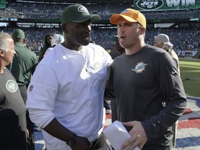 Miami Dolphins head coach Adam Gase, right, shakes hands with New York Jets head coach Todd Bowles after an NFL football game, Sunday, Sept. 24, 2017, in East Rutherford, N.J. The Jets won 20-6. (AP Photo/Bill Kostroun)