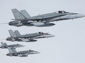 Canadian Fighter-18 (CF-18) Hornet Jets fly together during an Air to Air refuelling exercise.
