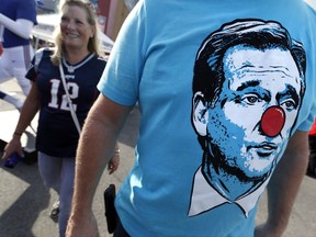 A fan wears a T-shirt bearing the face of NFL Commissioner Roger Goodell while tailgating in the parking lot of Gillette Stadium before a football game between the New England Patriots and the Kansas City Chiefs, Thursday, Sept. 7, 2017, in Foxborough, Mass. (AP Photo/Michael Dwyer)