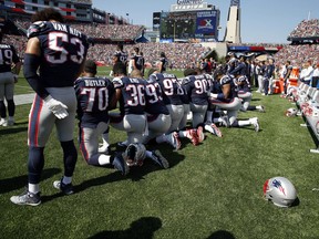 Several New England Patriots players kneel during the national anthem before an NFL football game against the Houston Texans, Sunday, Sept. 24, 2017, in Foxborough, Mass. (AP Photo/Michael Dwyer)