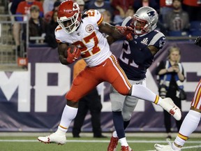 Kansas City Chiefs running back Kareem Hunt (27) eludes New England Patriots cornerback Malcolm Butler (21) as he crosses the goal line for a touchdown after catching a pass from Alex Smith during the second half of an NFL football game, Thursday, Sept. 7, 2017, in Foxborough, Mass. (AP Photo/Steven Senne)