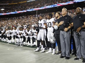 Some members of the Oakland Raiders sit on the bench during the national anthem before an NFL football game against the Washington Redskins in Landover, Md., Sunday, Sept. 24, 2017. (AP Photo/Alex Brandon)