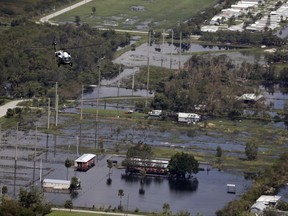 Marine One, with President Trump aboard, flies over areas impacted by Hurricane Irma, Thursday, Sept. 14, 2017, in Naples, Fla. (AP Photo/Evan Vucci)