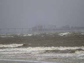 Fort Myers is seen as surf and winds begin to kick up in advance of Hurricane Irma, in Sanibel Island, Fla., Sunday, Sept. 10, 2017. Irma as turned towards the West coast of Florida and may give the Tampa area its first direct hit from a major hurricane in nearly a century. (AP Photo/Gerald Herbert)