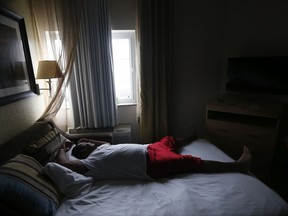 Arthur Shine, of Key West, Fla., watches from his hotel window as Hurricane Irma hits in Fort Myers, Fla., Sunday, Sept. 10, 2017. (AP Photo/Gerald Herbert)