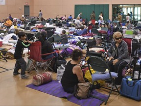 People seek shelter from Hurricane Irma at the West Boynton Park and Recreation Center in Boynton, Beach, Fla., on Saturday, Sept. 9, 2017.    (Jim Rassol /South Florida Sun-Sentinel via AP)