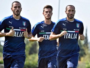 Italy's players, from left, Andrea Barzagli, Daniele Rugani and Giorgio Chiellini, jog during a training session at the Coverciano Sports Center near Florence, Italy, Tuesday, Aug. 29, 2017. Italy is scheduled to play Spain in a 2018 World Cup qualifying soccer match in Madrid on Sept. 2. (Maurizio degl'Innocenti/ANSA via AP)