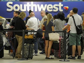Passengers wait in line at the Southwest Airlines ticket counter Wednesday, Sept.  6, 2017 at Tampa International Airport. Many passengers were leaving Tampa on Wednesday ahead of Hurricane Irma which is threatening the Florida peninsula.  (Chris Urso/Tampa Bay Times via AP)