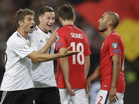 Germany's Julian Draxler, second from left, celebrates after scoring his side's second goal with his teammate Thomas Mueller, left, during the World Cup Group C qualifying soccer match between Germany and Norway in Stuttgart, Germany, Monday, Sept. 4, 2017. (AP Photo/Matthias Schrader)