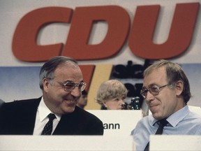 FILE - In this Nov. 1981 file photo Helmut Kohl, left, chairman of the West German Christian Democratic Union Party (CDU), talks with the party's secretary-general Heiner Geissler during the party convention in Hamburg,, northern Germany. Geissler has died, Sueddeutsche Zeitung reported Sept. 12, 2017. He was 87. (AP Photo/Heribert Proepper, file)