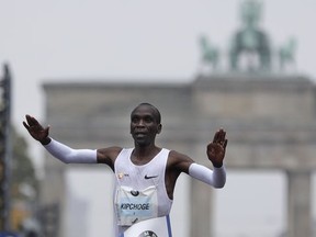 Kenya's Eliud Kipchoge crosses the line to win the 44th Berlin marathon in Berlin, Germany, Sunday, Sept. 24, 2017. (AP Photo/Michael Sohn)