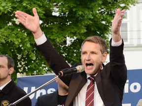 FILE - In this May 18, 2016 file photo the head of AfD in Thuringia Bjoern Hoecke speaks during a rally of nationalist Alternative for Germany against the planned building of a mosque in Erfurt, eastern Germany. The nationalist party that wants Germany to close its borders to migrants, leave Europe's common currency and end sanctions against Russia is predicted to enter Parliament for the first time this month, propelled by voters' anger at Chancellor Angela Merkel's decision to let over a million refugees into the country since 2015. (AP Photo/Jens Meyer, file)