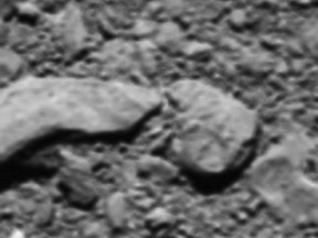 The image provided by the European Space Agency ESA on Thursday, Sept. 28, 2017 shows the reconstructed last image from Rosetta space probe. The final image from Rosetta, shortly before it made a controlled impact onto Comet 67P/Churyumov–Gerasimenko on Sept. 30, 2016 was reconstructed from residual telemetry. (ESA/Rosetta via AP)