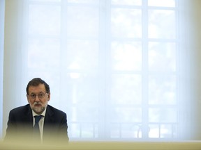 Spain's Prime Minister Mariano Rajoy talks to Socialist party leader Pedro Sanchez during their meeting at the Moncloa palace in Madrid, Thursday, Sept. 7, 2017. Rajoy and members of his cabinet met Thursday to react to plans by Catalan leaders who scheduled a vote on the region's independence from Spain. (AP Photo/Francisco Seco)
