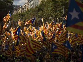 Catalans with estelada or independence flags gather during the Catalan National Day in Barcelona, Spain, Monday Sept. 11, 2017. Hundreds of thousands are expected to rally in Barcelona to show support for an independent Catalan nation and the right to vote in a controversial referendum that has been banned by Spain. (AP Photo/Francisco Seco)