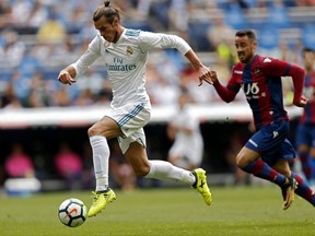 Real Madrid's Gareth Bale runs with the ball during the Spanish La Liga soccer match between Real Madrid and Levante at the Santiago Bernabeu stadium in Madrid, Saturday, Sept. 9, 2017. (AP Photo/Francisco Seco)