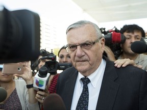 FILE- In this July 6, 2017, file photo, former Sheriff Joe Arpaio leaves the federal courthouse in Phoenix, Ariz.  Arpaio, who was pardoned by President Donald Trump from his federal contempt-of-court conviction in an immigration case is experiencing a wobbly return to the public speaking circuit. In Las Vegas, security concerns prompted event planners to move Arpaio's scheduled weekend appearance to an undisclosed location away from the casino-lined Strip tourist district. (AP Photo/Angie Wang, File)