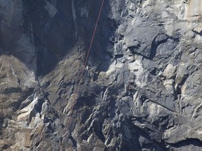 In this Wednesday Sept. 27, 2017, photo provided by Dakota Snider, photographer and Yosemite resident, a helicopter makes a rescue off El Capitan after a major rock fall in Yosemite National Park, Calif. All areas in California's Yosemite Valley are open Thursday, a day after the fatal rock fall. (Dakota Snider via AP)