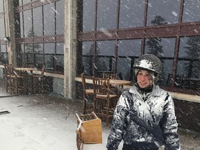 In this image provided by Northstar California, Jessie Hall, an employee at the Northstar California Resort looks out at the first snow of the season Thursday, Sept. 21, 2017, in Truckee, Calif. Snow is falling in the Sierra Nevada on the last day of summer, dusting hills and ski resorts with fresh snow and stoking excitement for an early skiing season. Forecasters say a rare cool weather system moving south from Oregon is bringing mountain rain and snow showers to the Sierra Thursday. Warmer and drier weather is expected by the weekend. (Northstar California via AP)