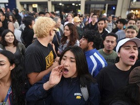 Protesters shout before a speaking engagement by Ben Shapiro on the campus of the University of California Berkeley in Berkeley, Calif., Thursday, Sept. 14, 2017. Several streets around the University of California, Berkeley, were closed off Thursday with concrete and plastic barriers ahead of an evening appearance by the conservative commentator.