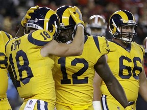 Los Angeles Rams wide receiver Sammy Watkins (12) is congratulated by Cooper Kupp (18) after scoring a touchdown against the San Francisco 49ers during the second half of an NFL football game in Santa Clara, Calif., Thursday, Sept. 21, 2017. (AP Photo/Ben Margot)