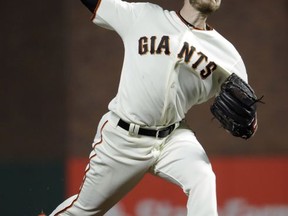 San Francisco Giants starter Chris Stratton throws to the Los Angeles Dodgers during the first inning of a baseball game, Monday, Sept. 11, 2017, in San Francisco. (AP Photo/Marcio Jose Sanchez)