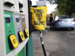 A "Sorry out of Service" sign is placed on one of the gas pumps at a gas station in Athens, Ga., on Friday, Sept. 1, 2017. Gasoline prices in the U.S. have risen to new high amid continuing fears of shortages in Texas and other states after Hurricane Harvey's strike. (Joshua L. Jones/Athens Banner-Herald via AP)