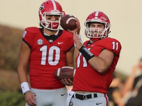 Injured Georgia quarterback Jacob Eason watches as Jake Fromm warms up for the team's NCAA college football game against Mississippi State on Saturday, Sept. 23, 2017, in Athens, Ga. (Curtis Compton/Atlanta Journal-Constitution via AP)