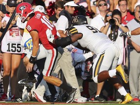 Georgia quarterback Jacob Eason is pushed out of bounds by Appalachian State defender Myquon Stout, who was penalized on the play during the first quarter of an NCAA college football game Saturday, Sept. 2, 2017, in Athens, Ga. Eason left the game. (Curtis Compton/Atlanta Journal-Constitution via AP)