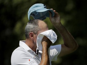 Matt Kuchar wipes away sweat before teeing off on the second hole during the first round of the Tour Championship golf tournament at East Lake Golf Club in Atlanta, Thursday, Sept. 21, 2017. (AP Photo/David Goldman)
