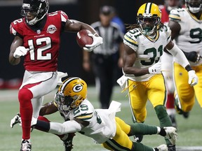Atlanta Falcons wide receiver Mohamed Sanu (12) runs by Green Bay Packers defensive back Kentrell Brice (29) during the first of an NFL football game, Sunday, Sept. 17, 2017, in Atlanta. (AP Photo/John Bazemore)
