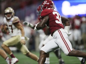 Alabama linebacker Rashaan Evans (32) picks up a blocked field goal attempt against Florida State during the first half of an NCAA football game, Saturday, Sept. 2, 2017, in Atlanta. (AP Photo/John Bazemore)