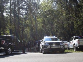 Polk County, Ga. law enforcement officials look for a suspect involved in a shooting that killed a police officer and injured another, Friday, Sept. 29, 2017, in Cedartown, Ga. The suspect, Seth Brandon Spangler, was taken into custody. He faces murder and aggravated assault charges. (Kevin Myrick/Polk County Standard Journal via AP)